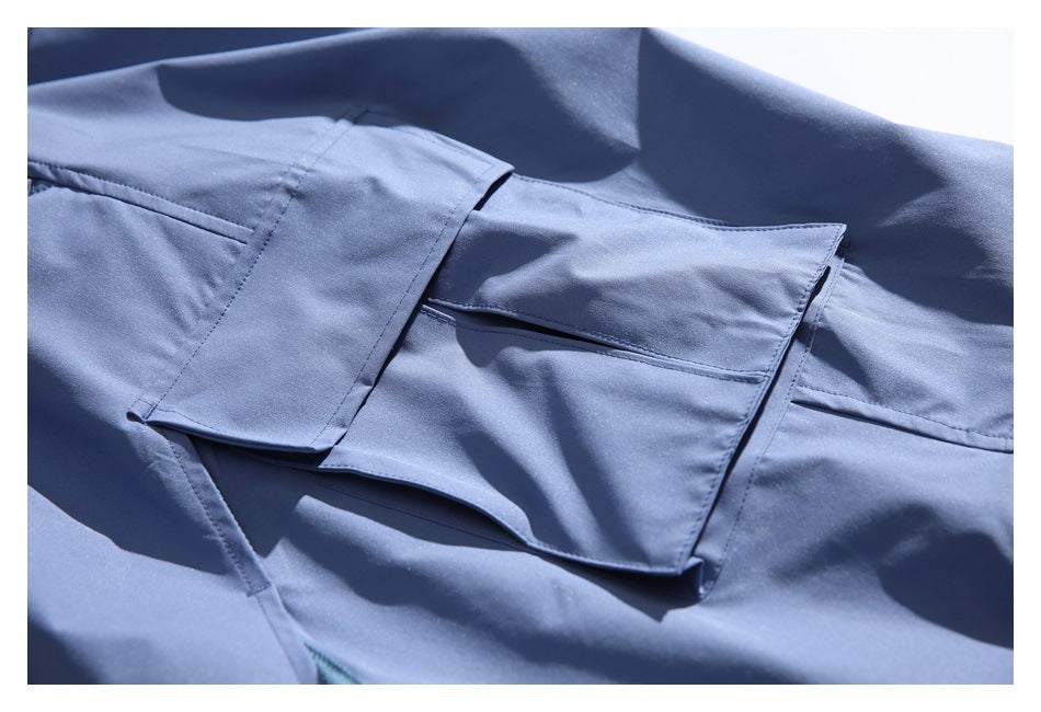 Close-up of a flap cargo pocket on blue shorts.