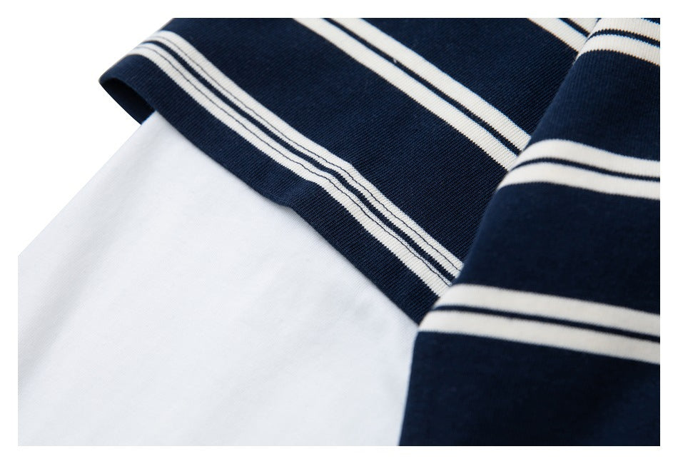 Close-up of the striped short sleeve layered over a plain white long sleeve.