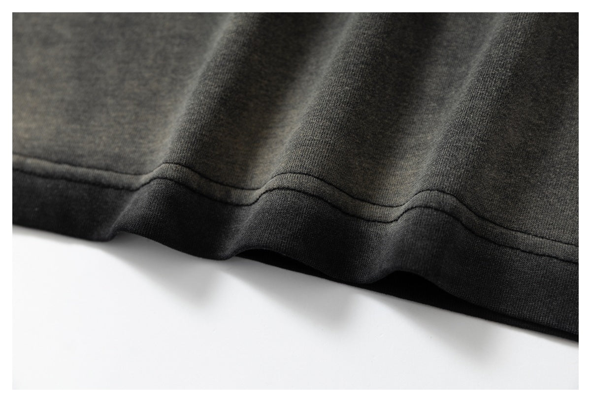 Close-up of the dark garment's lower hem, showing the seam and fabric folds.