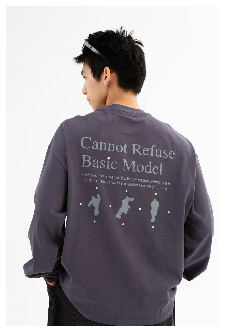 Back view of a model wearing a charcoal-gray sweatshirt with large English text and a graphic across the back.