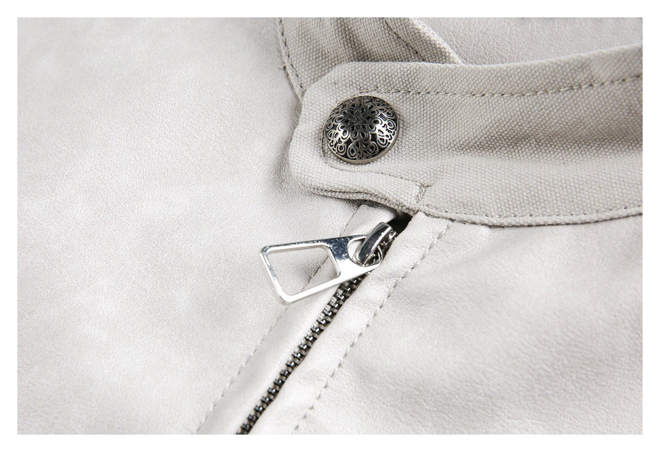 Close-up of a decorative metal snap and zipper pull on the light gray jacket.