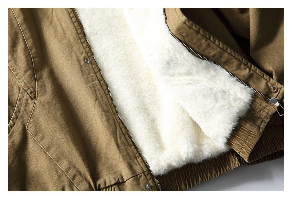 Close-up of a tan jacket opened to show its plush white lining, front zipper, and snap fasteners.