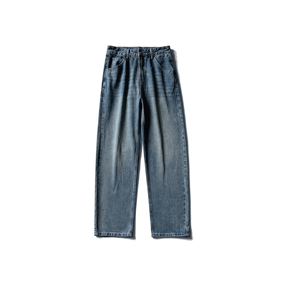 Front view of washed blue wide-leg denim jeans with button closure, belt loops and slanted front pockets