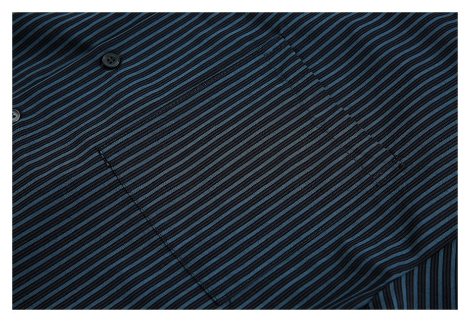Close-up of the black and blue striped shirt front with buttons and a stitched placket.