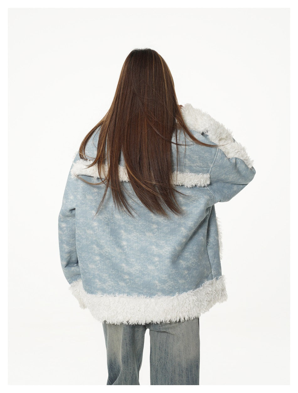 Back view of a model wearing a light blue jacket with white shaggy trim at the shoulders and hem, with loose jeans.