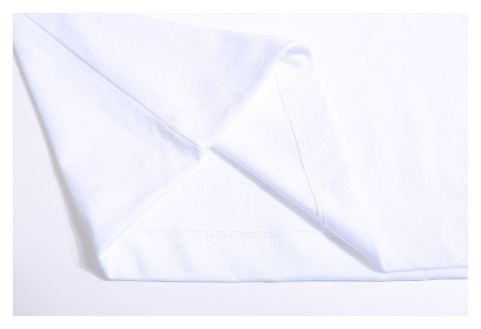 Close-up of the white T-shirt's stitched sleeve and side seam.