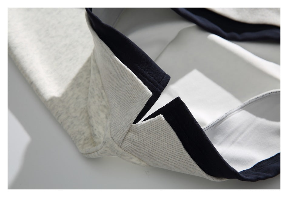 Close-up of a heathered light-gray sweatshirt neckline with dark navy trim and a white inner panel.