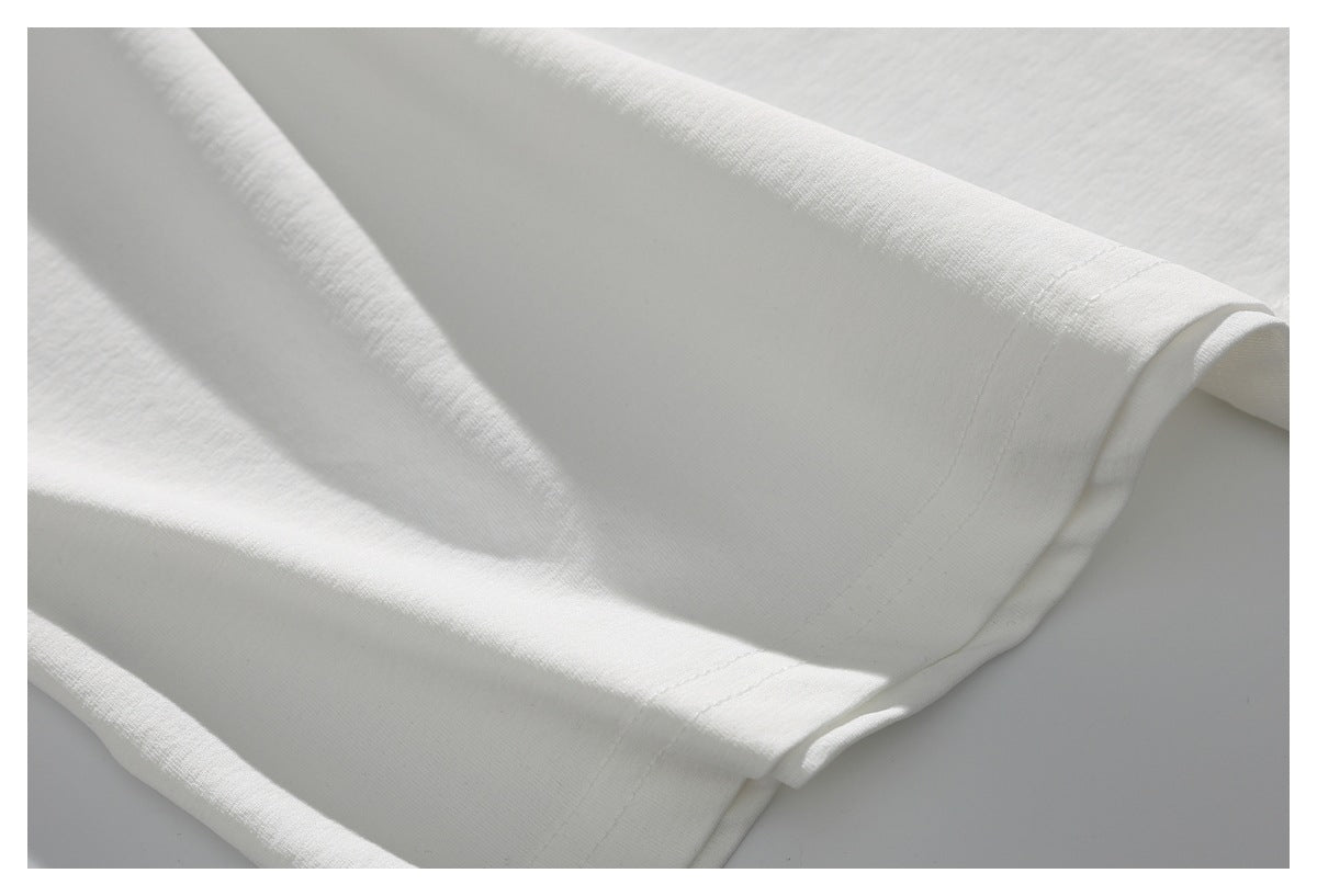 Close-up of a white garment hem with a neatly stitched edge.