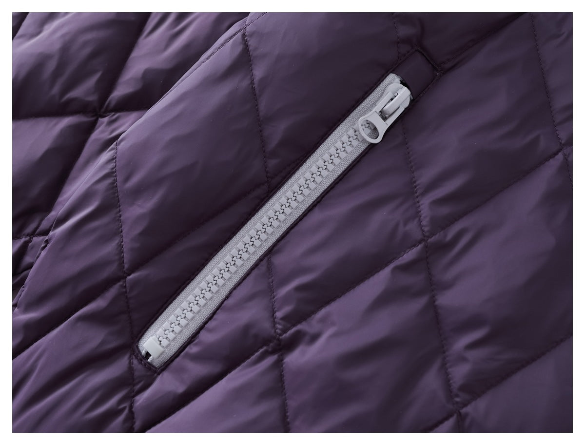 Close-up of a light gray diagonal zipper on a dark purple quilted garment.