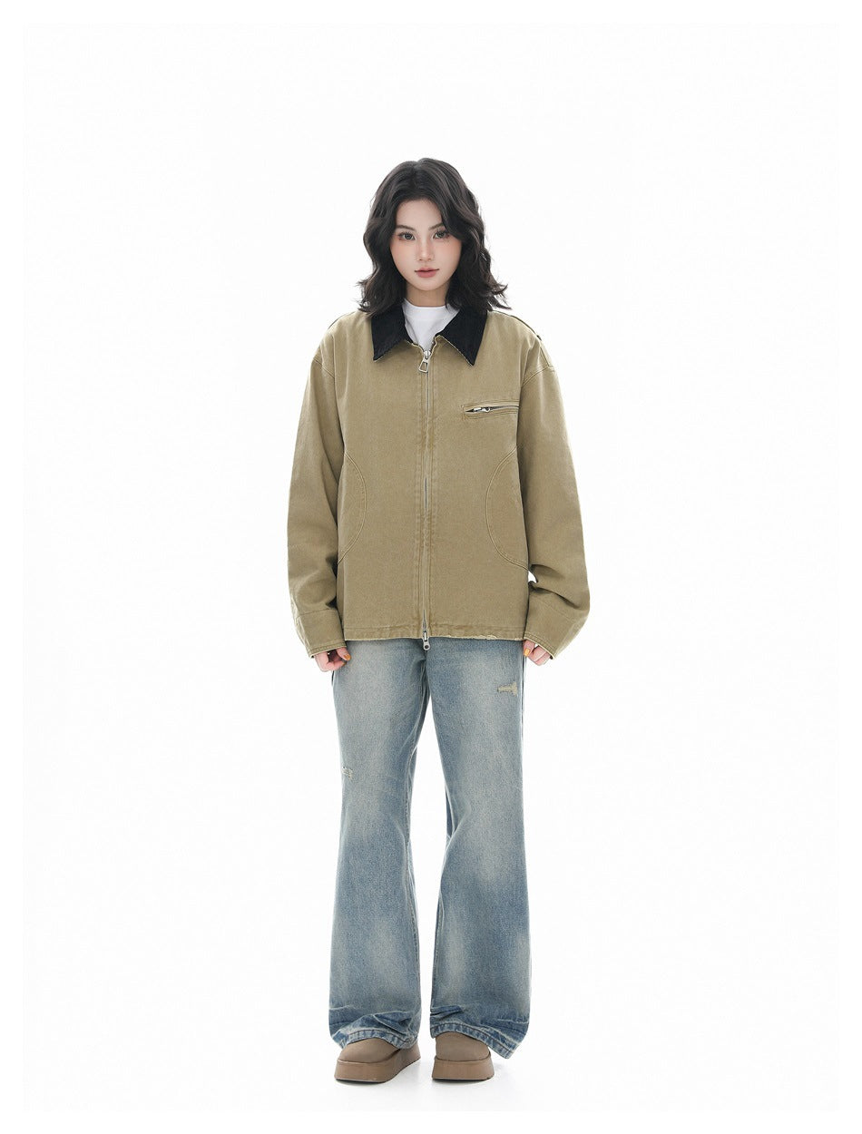 Full-length model wearing a khaki zip-front jacket with a black collar, loose blue jeans and brown shoes.