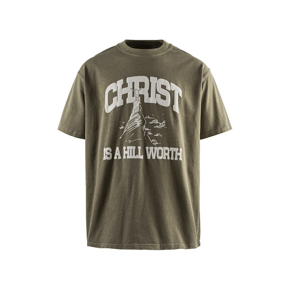 Front view of an olive-gray T-shirt with a large white religious graphic and text across the chest.