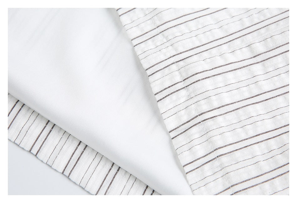 Close-up showing the white inner lining beside striped white fabric.