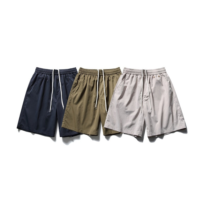 Three pairs of drawstring shorts shown together in navy, olive, and light gray.