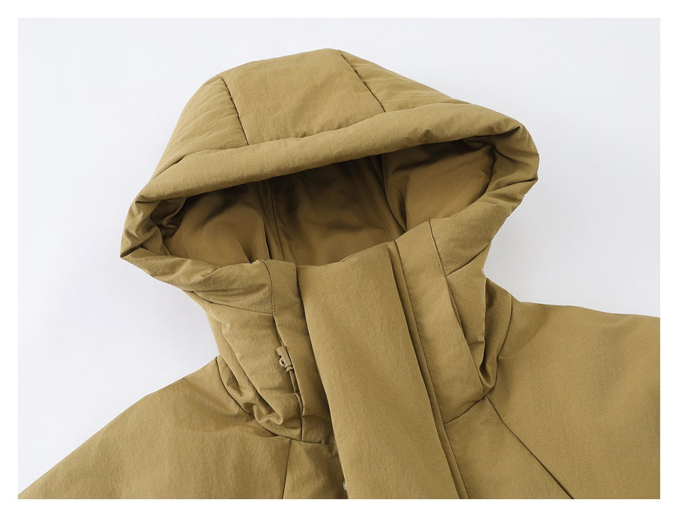 Close-up of the tan jacket's oversized hood, showing its padded panels and inner lining.