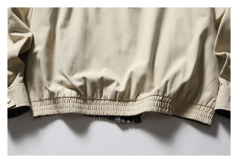Close-up of the beige jacket's gathered elastic back hem and sleeve cuffs.