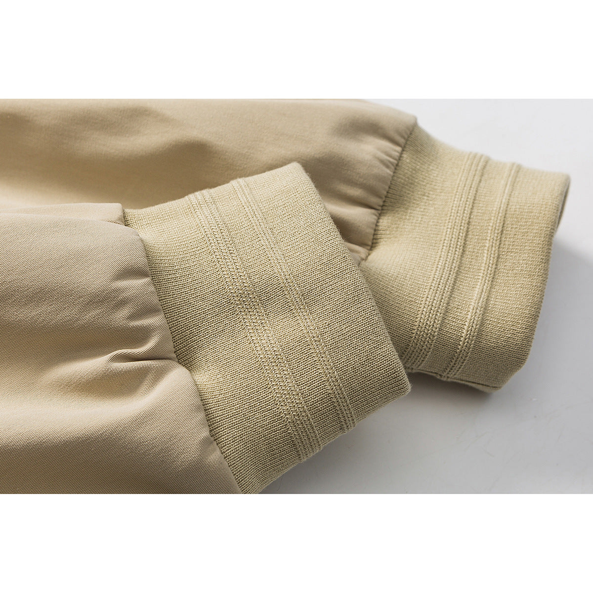 Close-up of the tan jacket sleeve and its wide ribbed knit cuff.