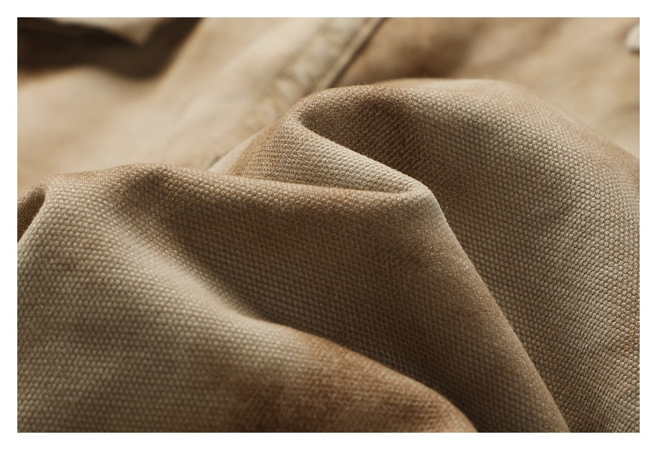 Macro view of the tan garment's woven surface and textured folds.