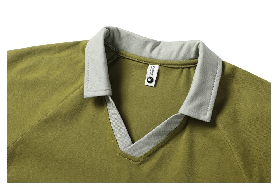 Close-up of the olive shirt's off-white collar, V-neck trim, shoulder seams, and inner size label.