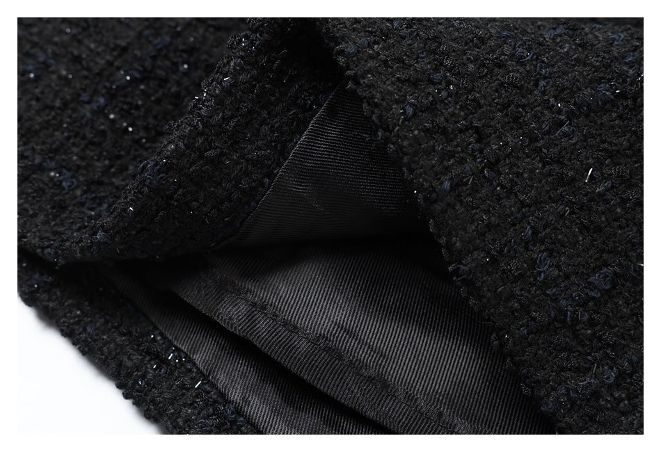 Close-up showing black lining beneath folded, textured black outer fabric.