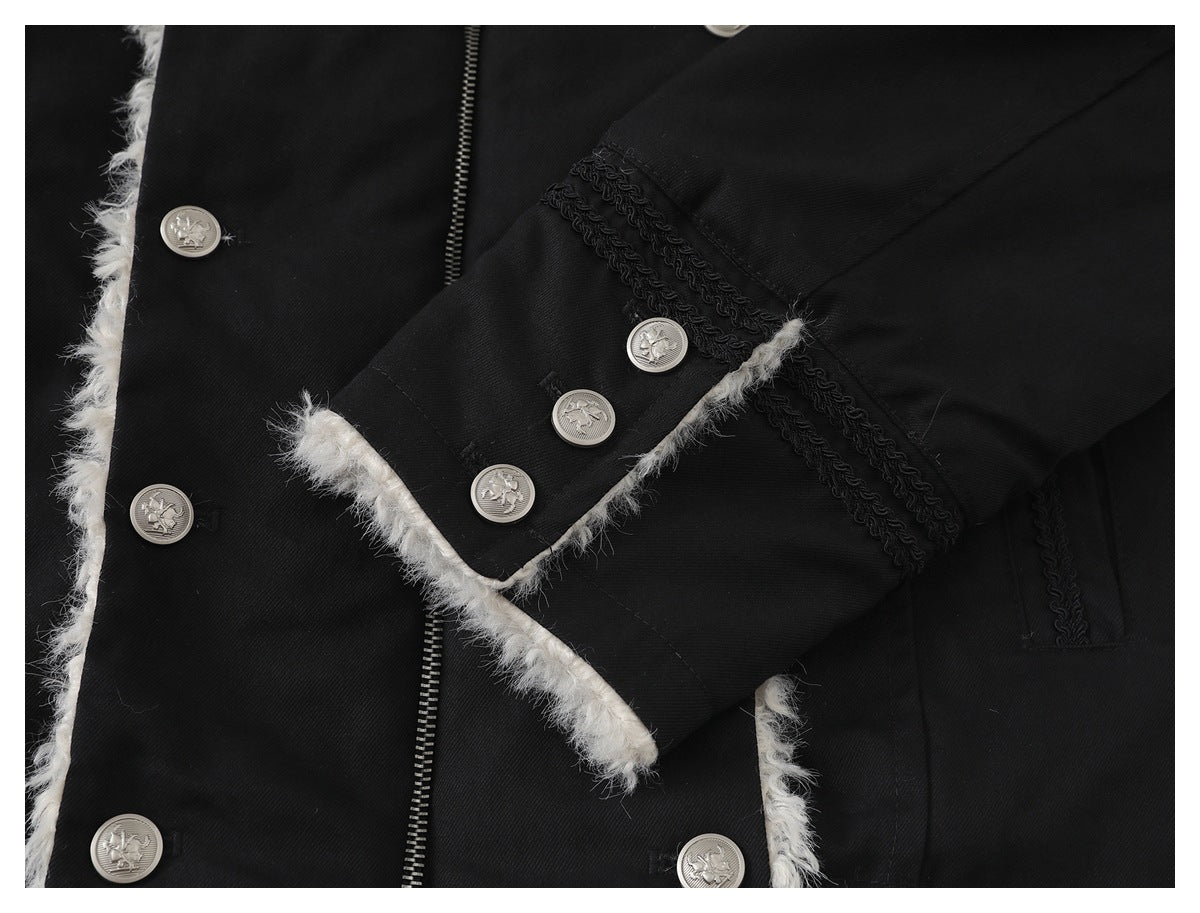 Close-up of a black coat sleeve cuff with silver buttons, black braid trim, and fluffy white edging.
