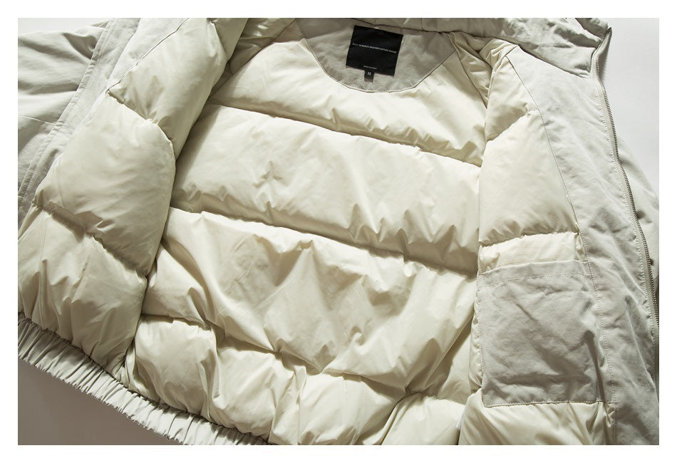 Light beige padded jacket opened flat, showing its quilted lining, pockets, and neck label.