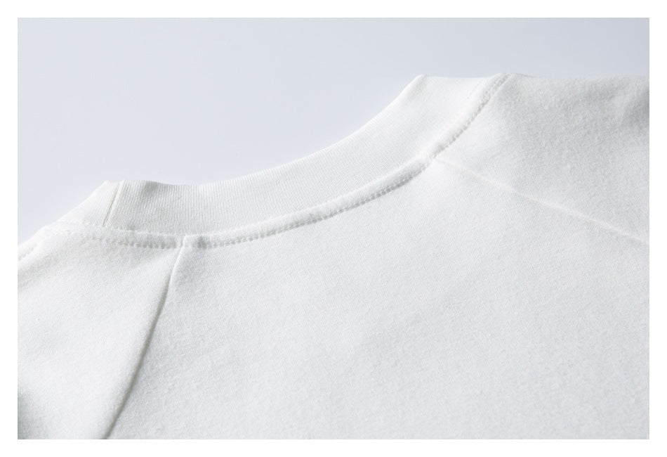 Close-up of the back neckline and shoulder seam of a white garment.