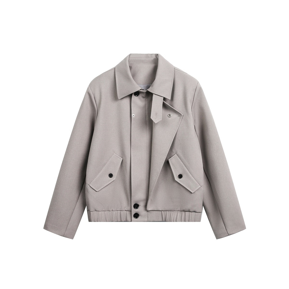Front view of a light taupe jacket with a pointed collar, asymmetrical button front, angled flap pockets, and ribbed hem.