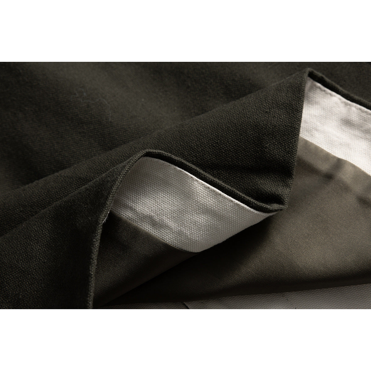 Close-up of the jacket's dark outer fabric and pale inner lining.