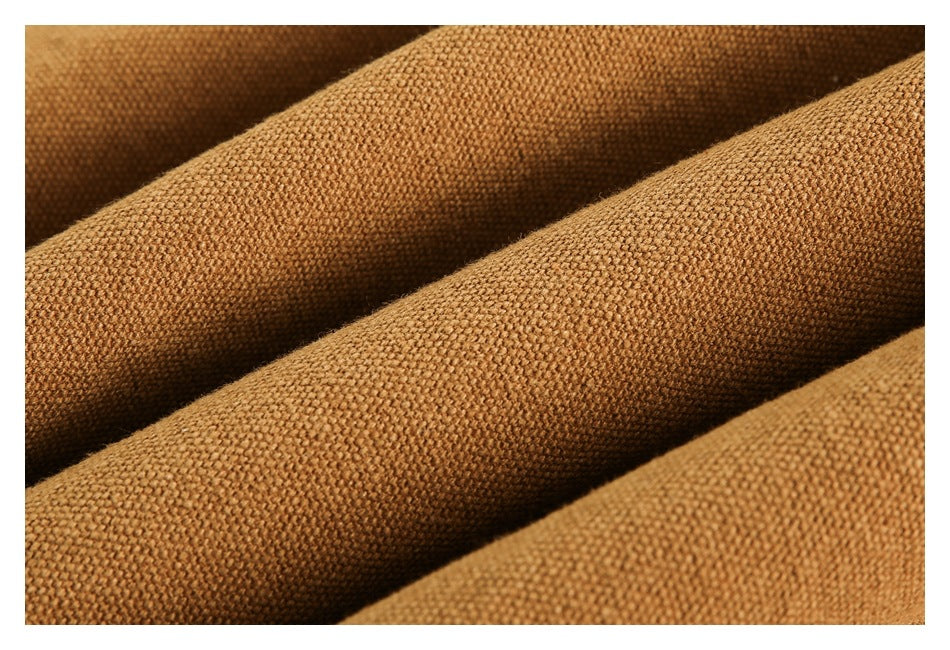 Macro view of the camel-brown garment's coarse woven-looking surface and folds.