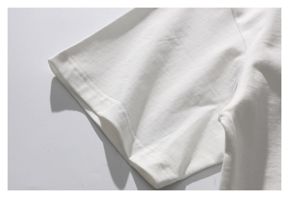 Close-up of the white T-shirt sleeve and stitched hem.