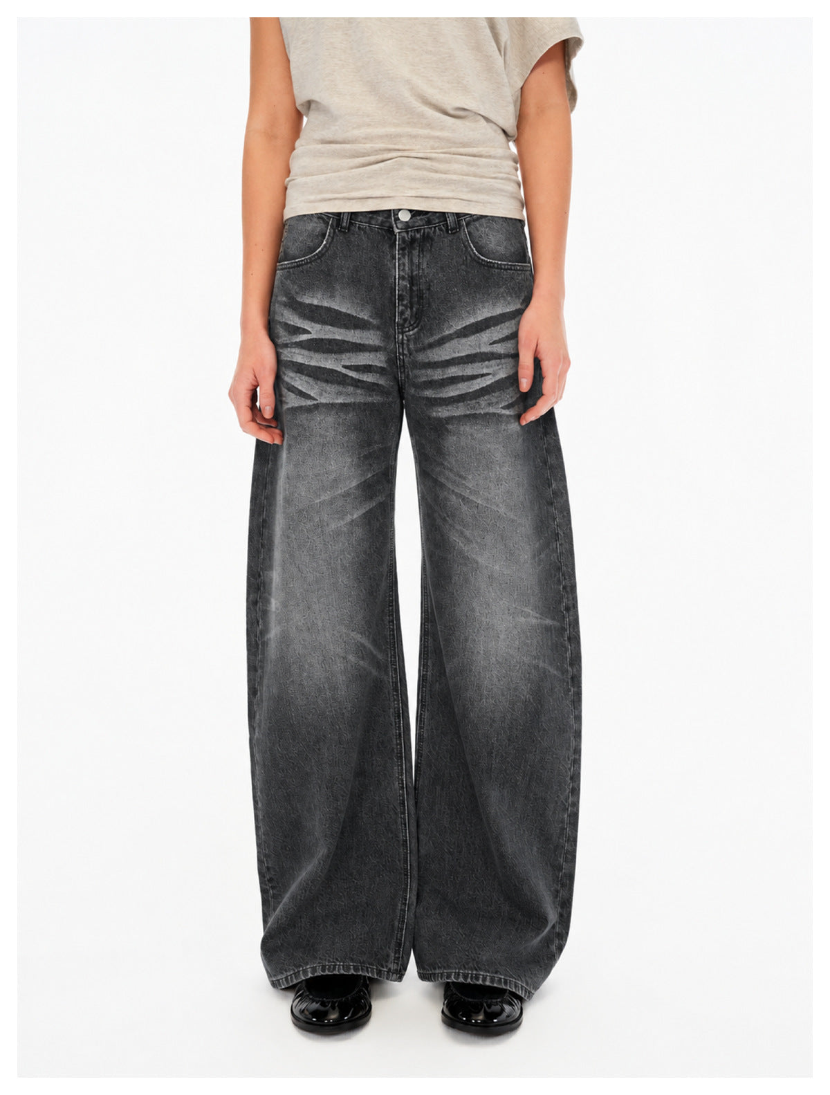 Front view of a person wearing charcoal wide-leg jeans with faded stripe details.