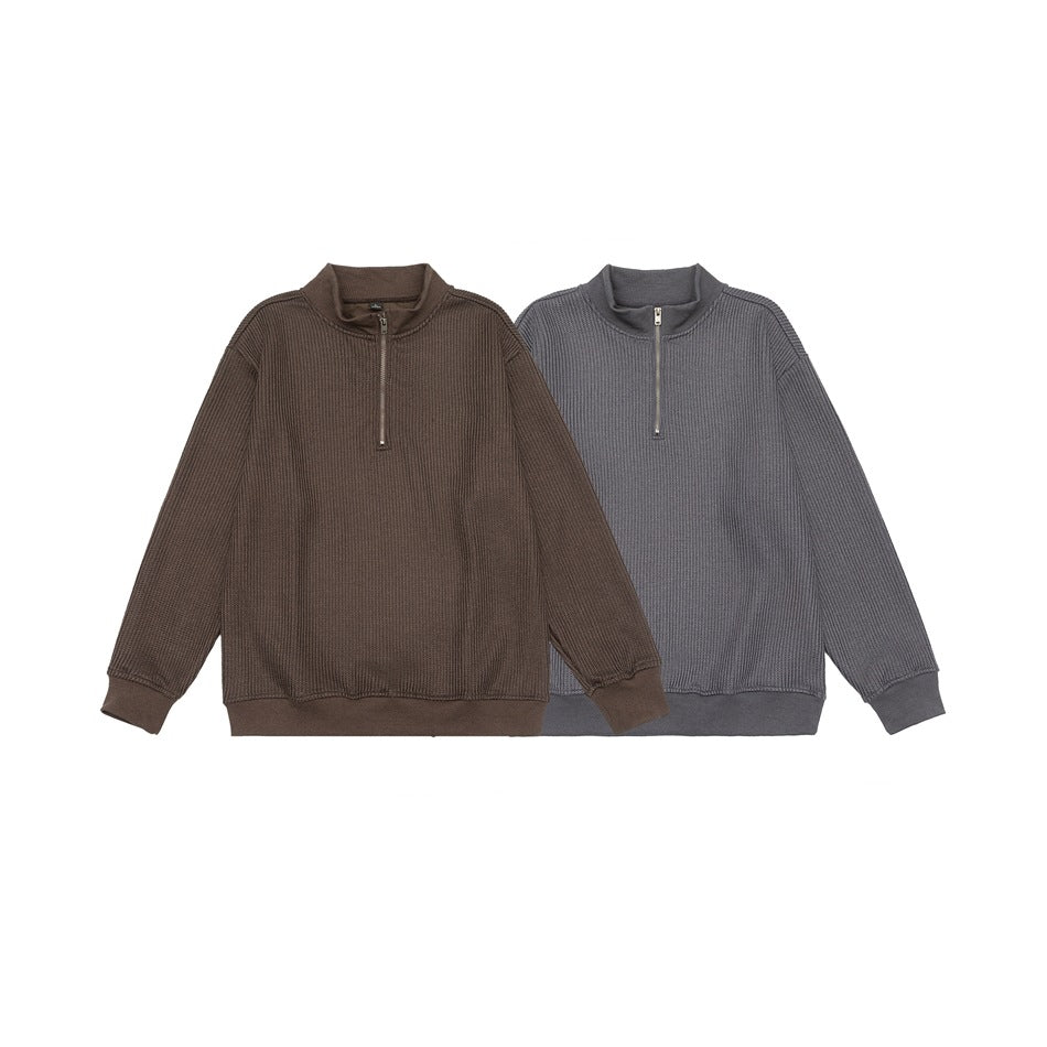 Two textured half-zip pullovers shown together: brown and charcoal gray.
