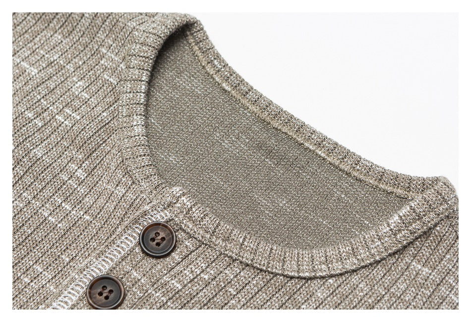 Close-up of the taupe marled shirt's crew neckline and two dark buttons.