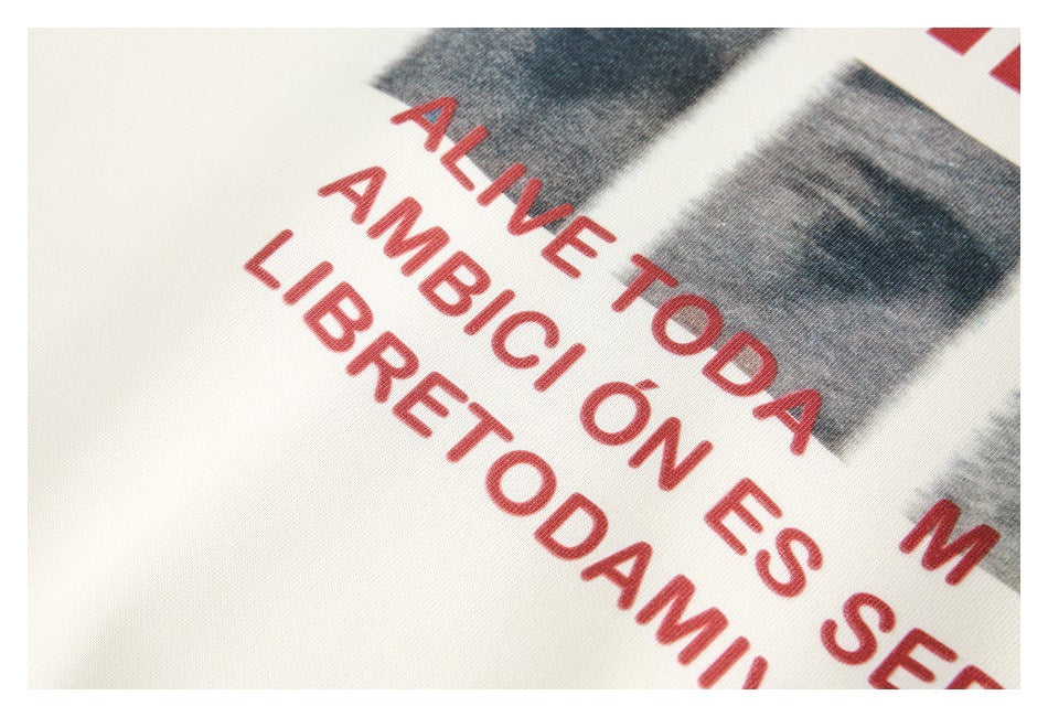 Tight close-up of red English lettering and grayscale print on ivory fabric.