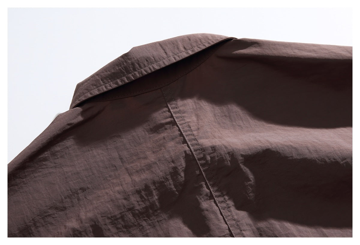 Close-up of the brown jacket's collar and back shoulder seam.