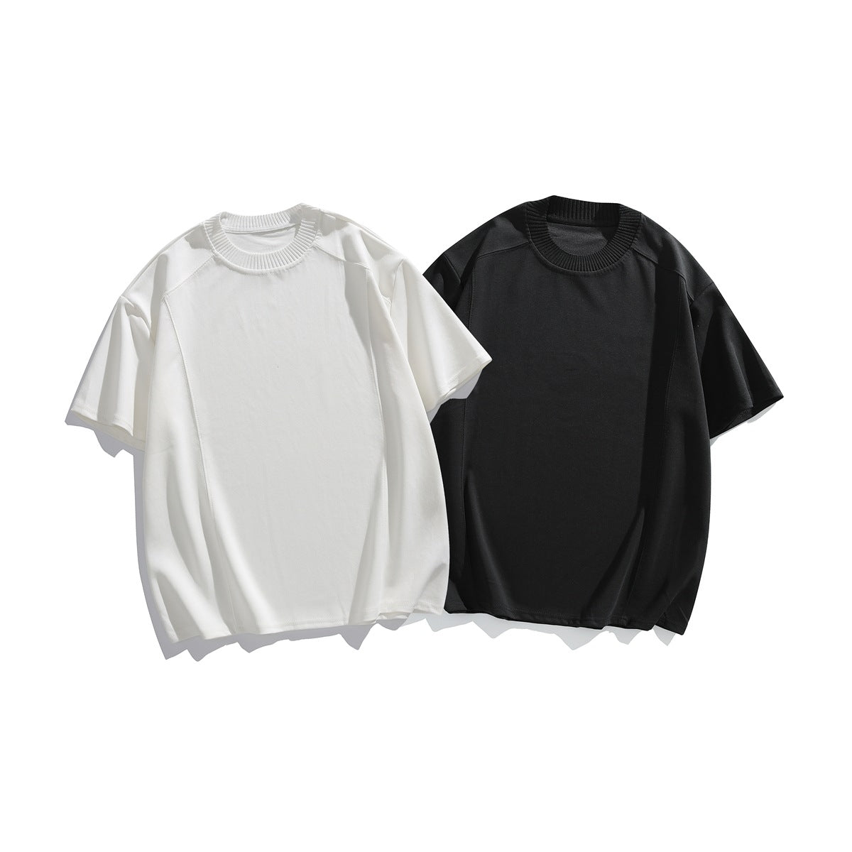 Front view of two short-sleeve crew-neck T-shirts, one white and one black, shown flat against a white background.