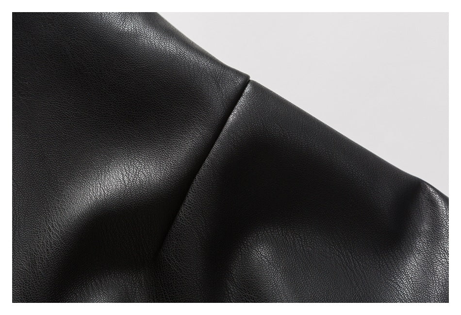 Close-up of a black jacket sleeve seam against a light background.