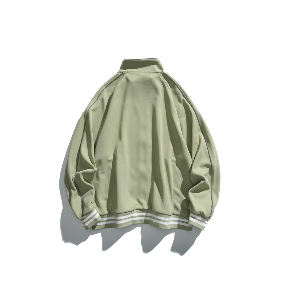 Back view of a sage-green track jacket with dark piping and striped ribbed cuffs and hem.
