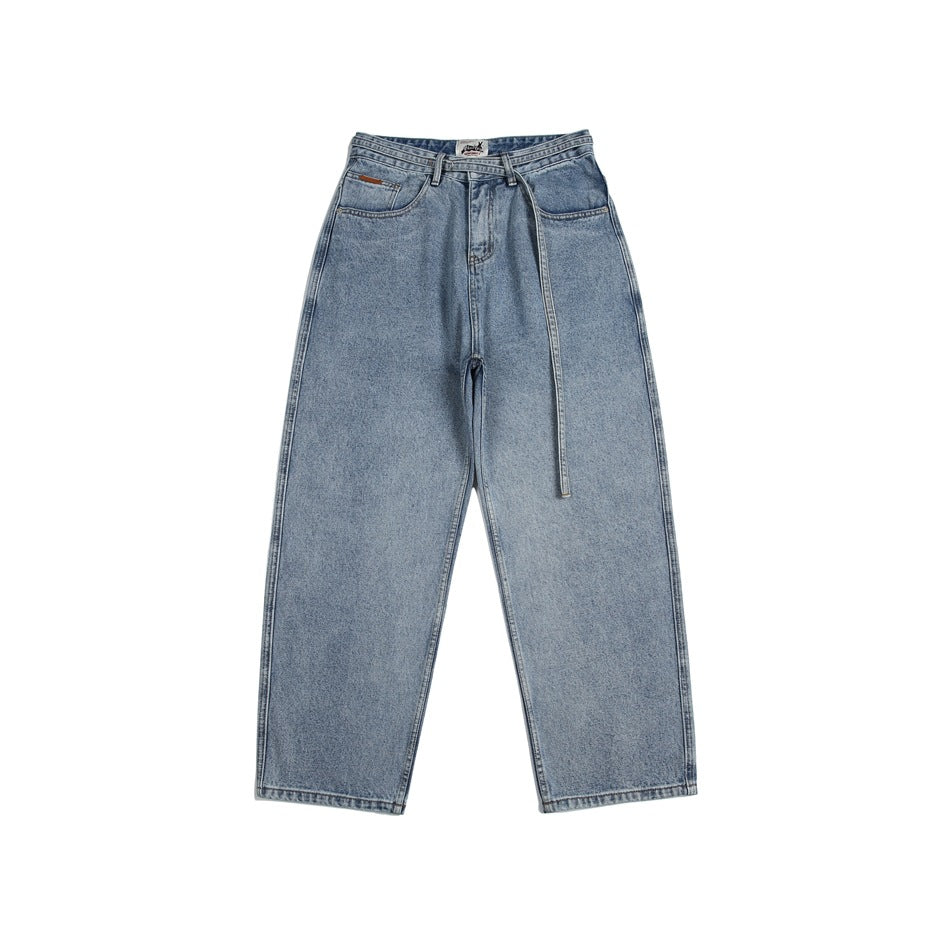 Front view of light-wash, wide-leg jeans with a long matching belt hanging from the waist.