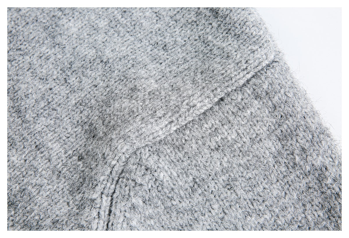 Close-up showing a raised seam and knit texture in light gray fabric.