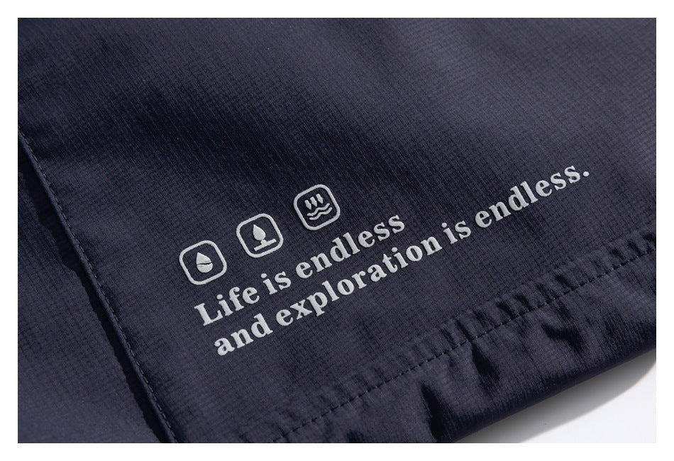 White outdoor-themed icons and the phrase “Life is endless and exploration is endless” printed on dark fabric.