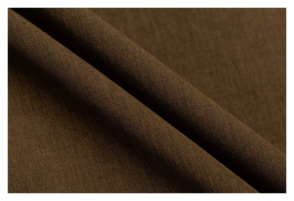 Close-up showing the textured brown jacket fabric folded into soft ridges.