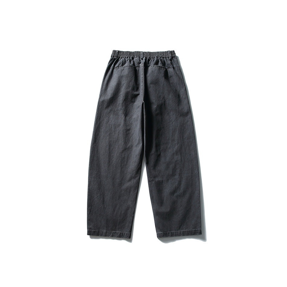 Back view of dark gray wide-leg pants with elastic waistband and back yoke seam, flat lay