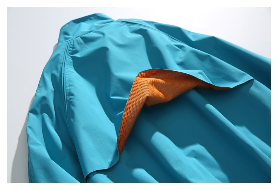 Turquoise garment opened to reveal orange mesh lining beneath the outer fabric.