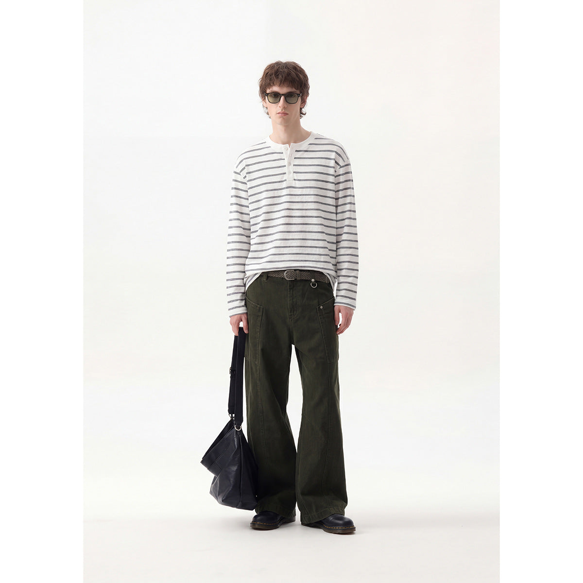Full-length model wearing a white and gray striped long-sleeve henley with dark olive wide-leg cargo pants.
