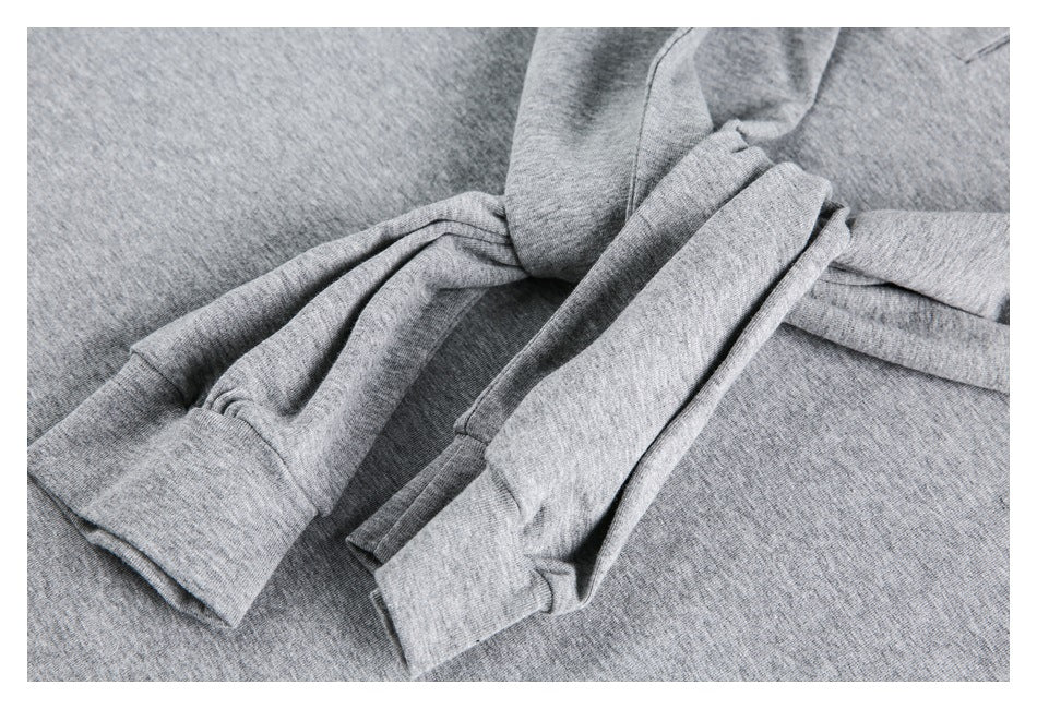 Close-up of the heather gray top's folded sleeves and stitched cuffs.