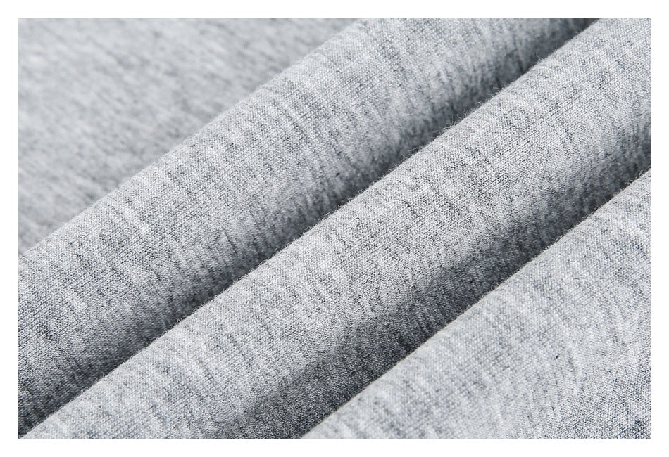 Close-up of the textured knit surface of light gray heathered fabric.