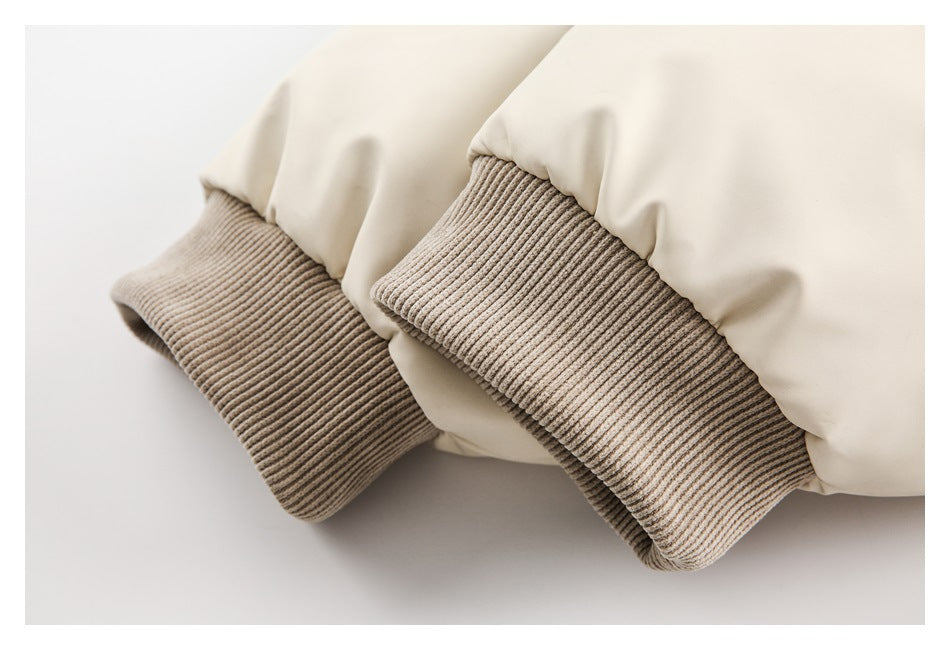 Close-up of the cream jacket's taupe ribbed cuffs.