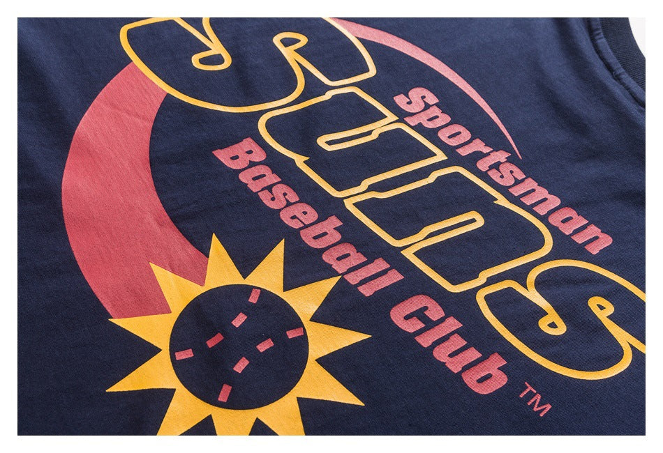 Close-up of a navy garment with a colorful yellow and red sports and baseball club graphic.