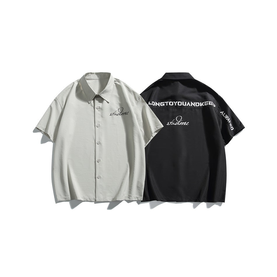 Light gray shirt shown from the front beside a black shirt shown from the back; both have graphic lettering.